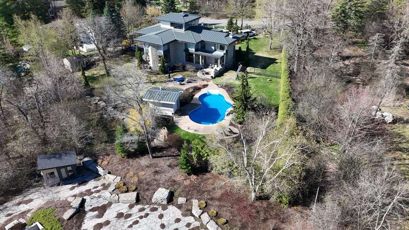 Aerial view of backyard with pool and rock garden landscaping
